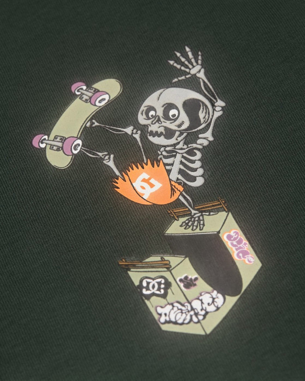 Lockwood Avenue DC Shoes youth t-shirt in dark green cotton featuring a skeleton performing a skateboard handplant.