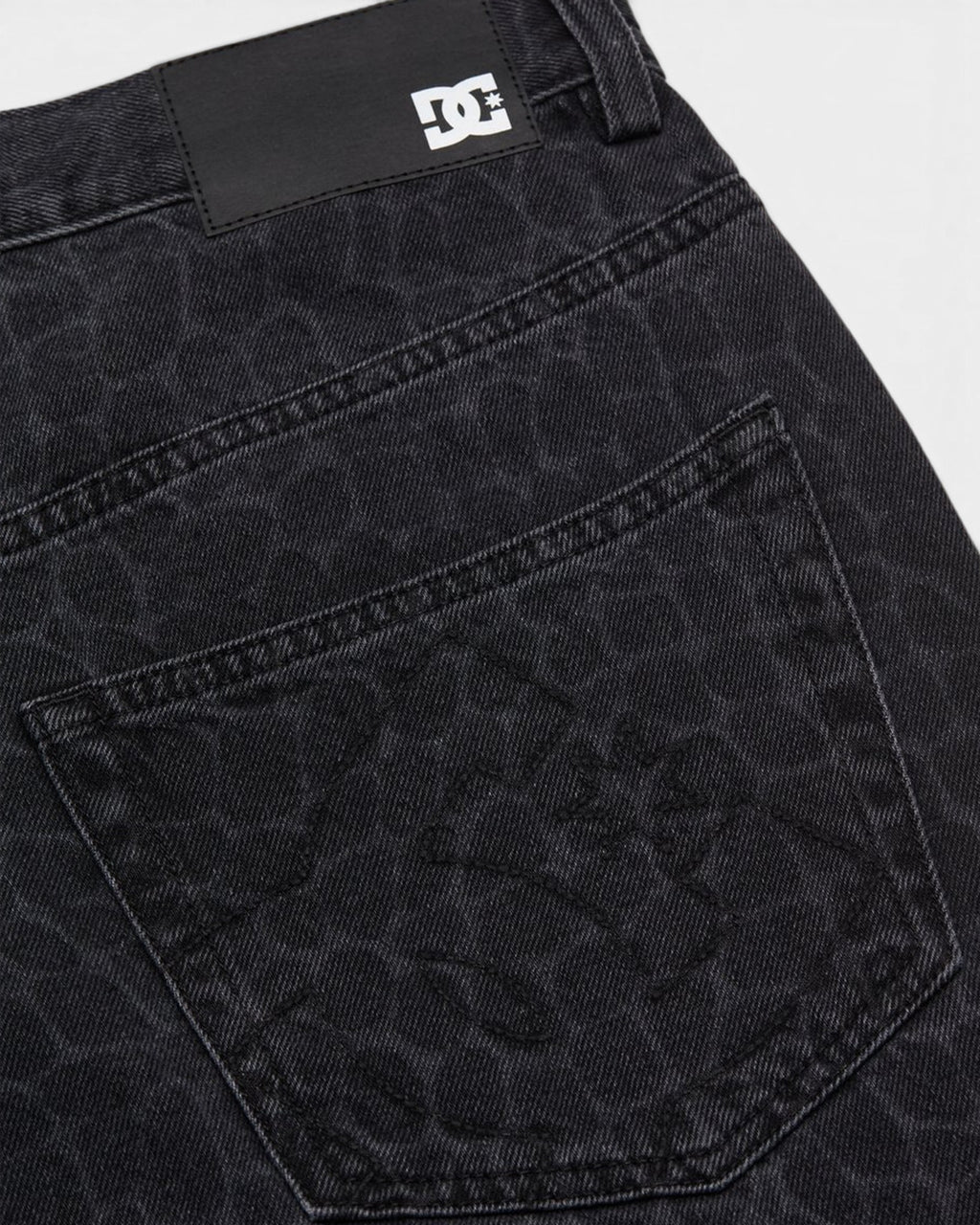 Lockwood Avenue DC baggy denim jeans in black with a subtle snake skin pattern and branded leather back patch