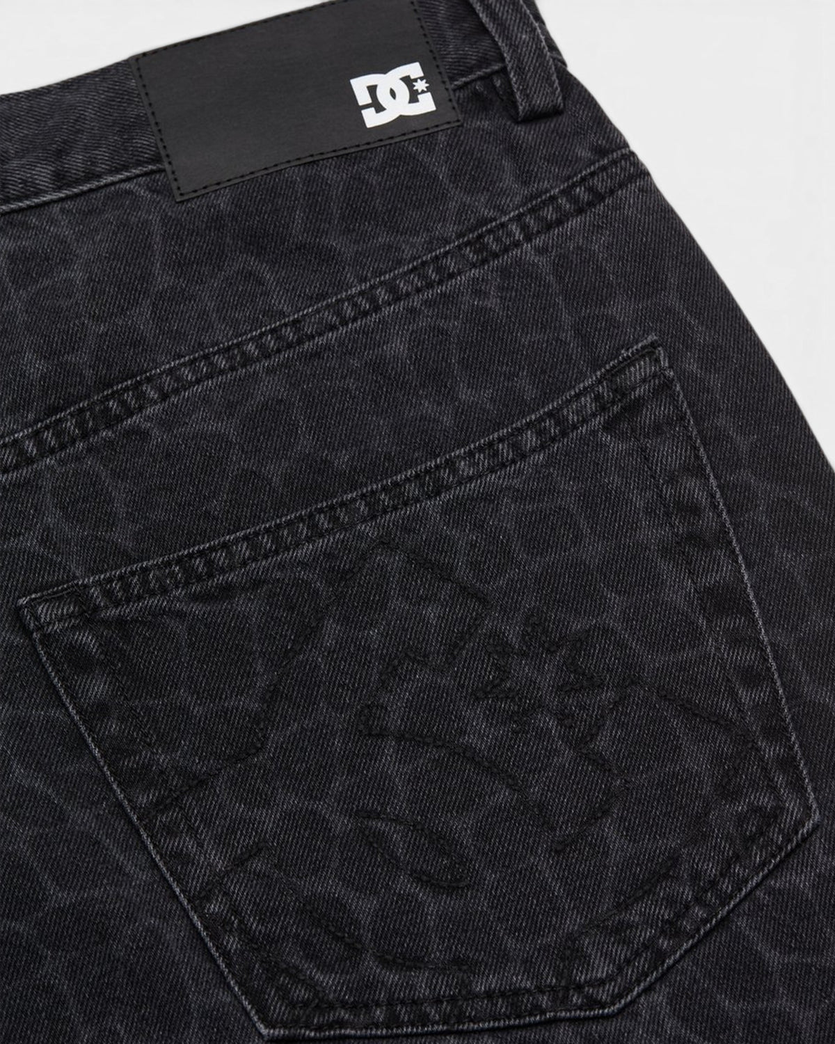 Lockwood Avenue DC baggy denim jeans in black with a subtle snake skin pattern and branded leather back patch