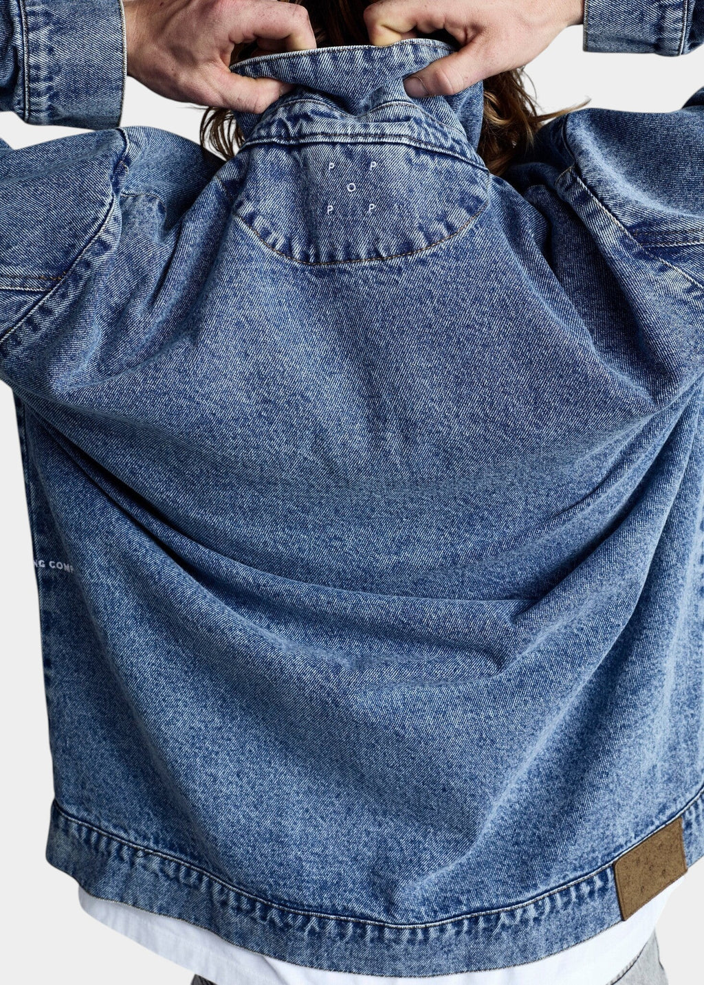 Lockwood Avenue Pop Trading Company blue denim jacket with half-moon back stitching and embroidered logo detail