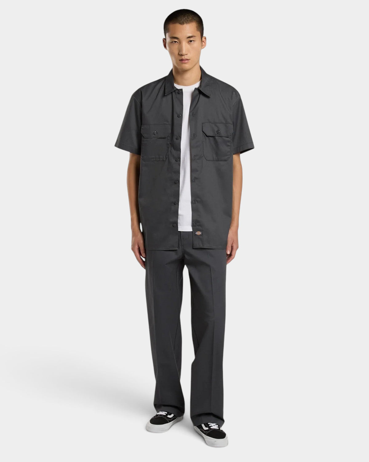 Lockwood Avenue model wearing Dickies 247 loose charcoal grey cotton twill work pants with a tailored silhouette