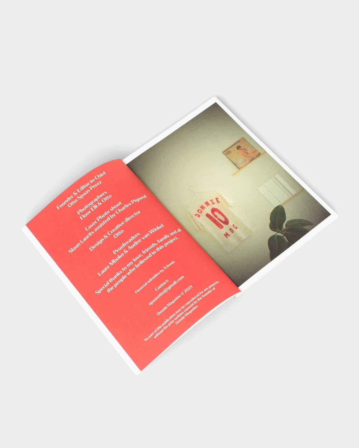 Lockwood Avenue Donnie Magazine Issue 1 open to the credits page with a photo of a white t-shirt on a wall