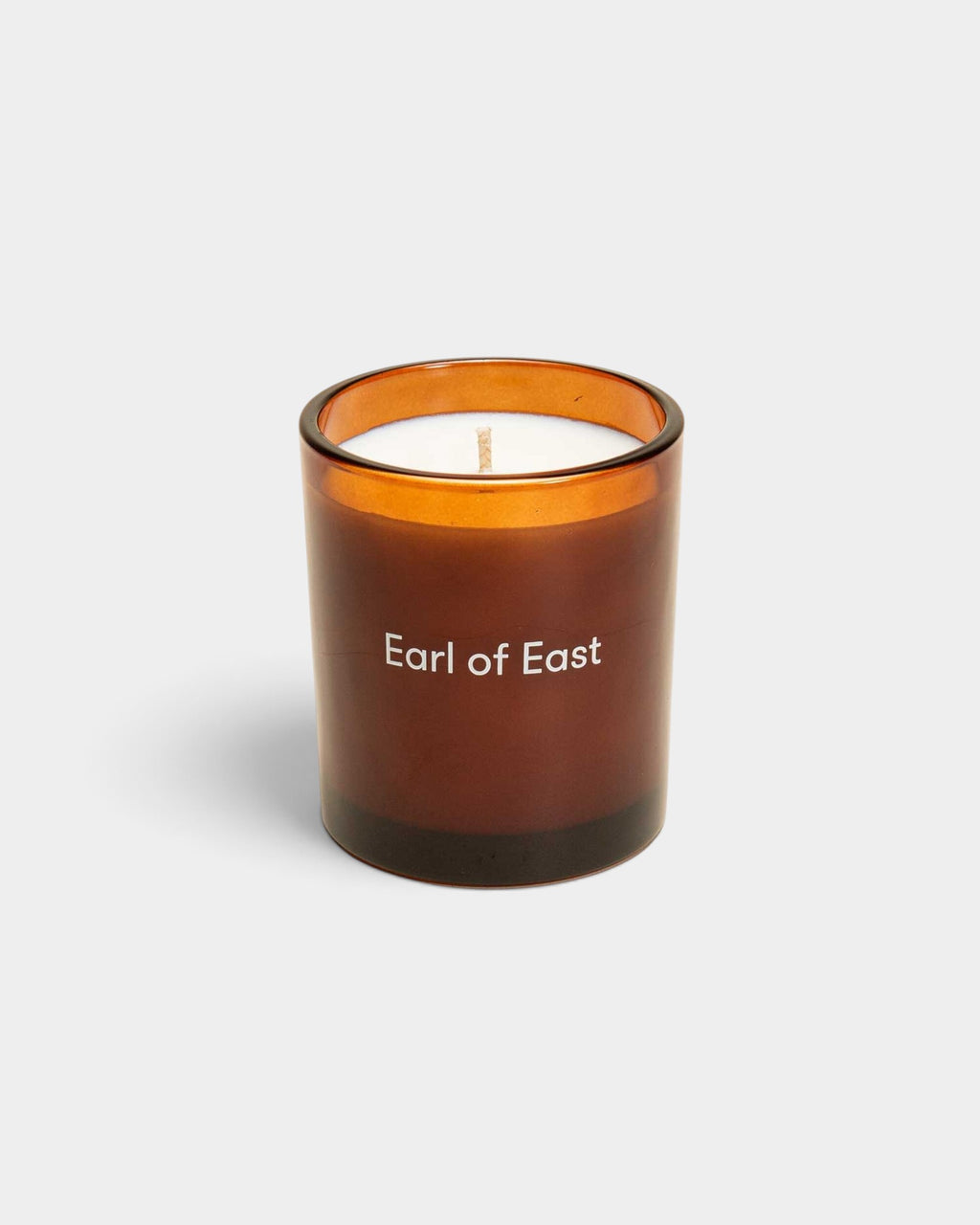 Lockwood Avenue Earl of East Smoke & Musk soy wax candle in a luxury amber glass vessel with white branding.
