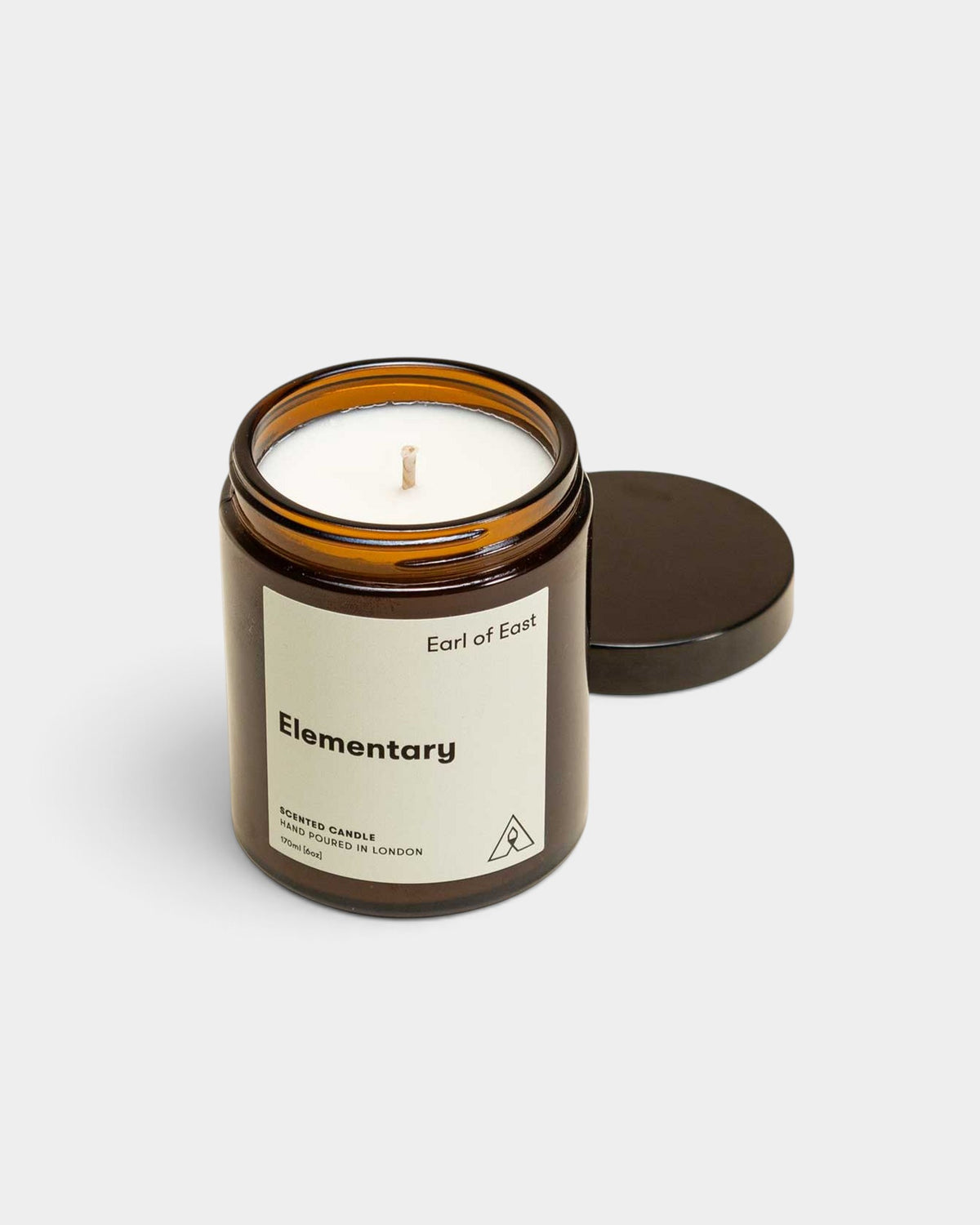 Lockwood Avenue Earl of East Elementary soy wax candle in a recyclable amber glass jar with a black lid