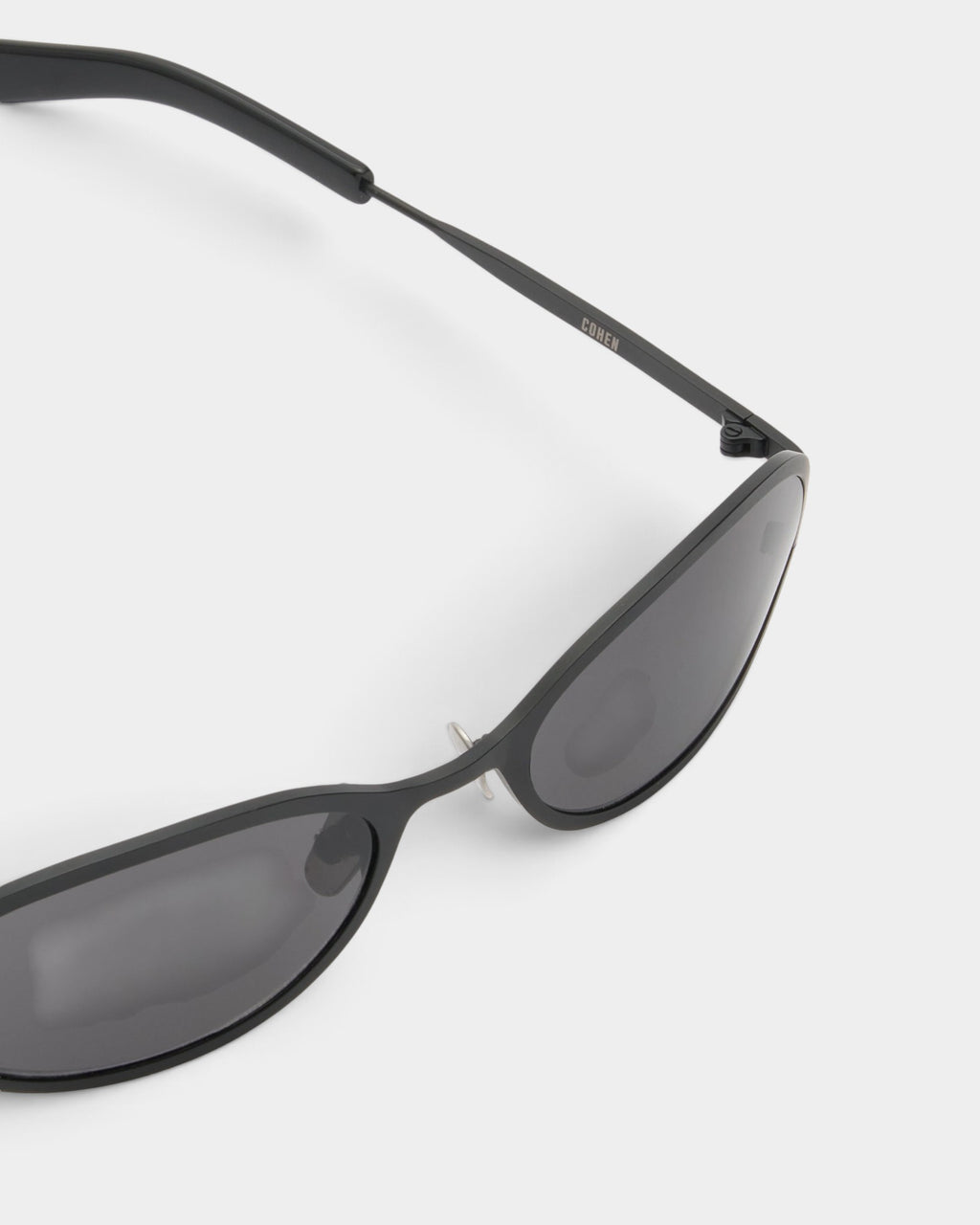 Lockwood Avenue Flatlist Cohen sunglasses in solid black with titanium frames and Carl Zeiss lenses, close-up view