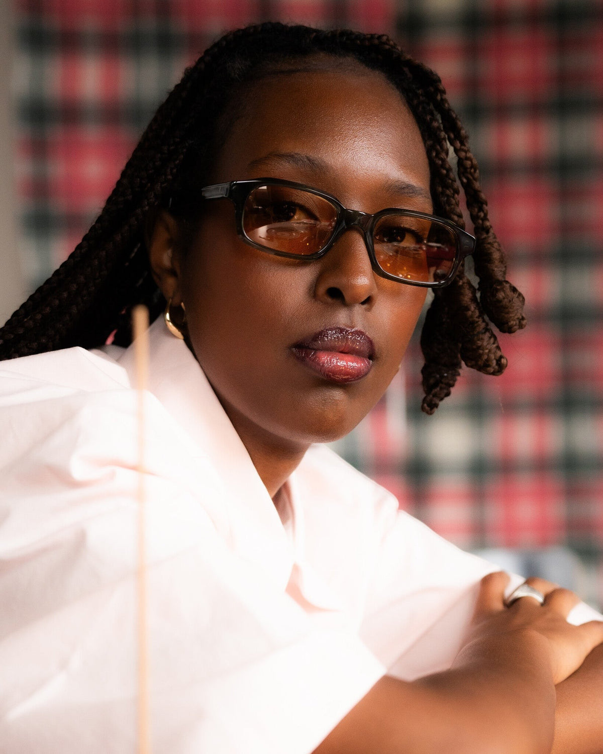 Lockwood Avenue Flatlist Hanky slim rectangular black acetate sunglasses worn by a woman with braided hair