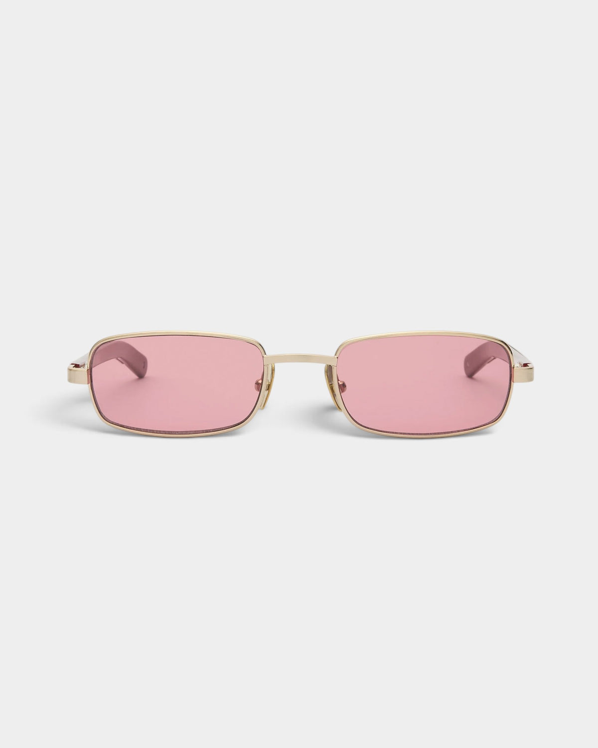 Lockwood Avenue Flatlist Sting sunglasses featuring a brushed light gold titanium frame and pink tinted lenses.