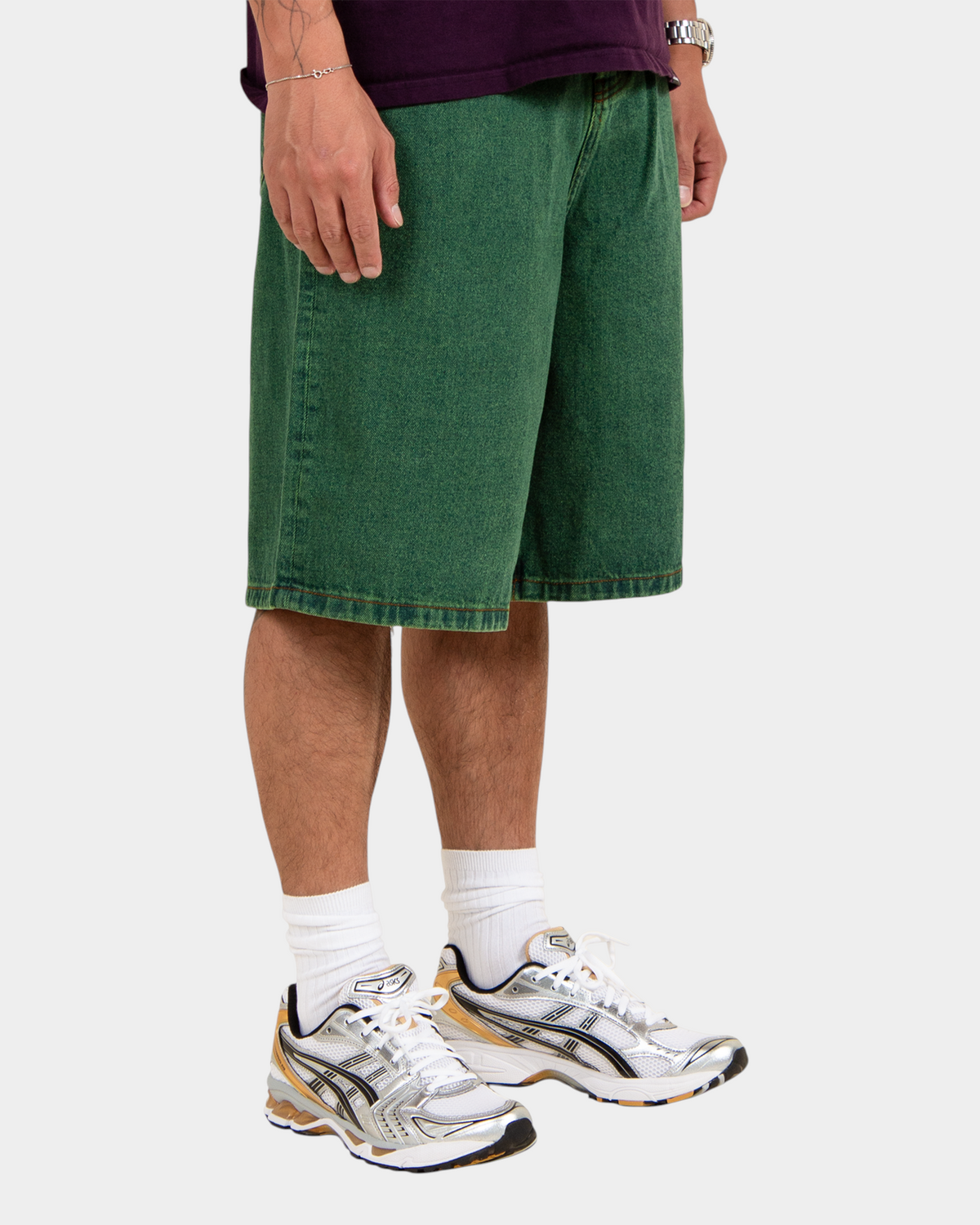 Lockwood Avenue baggy denim shorts in overdye green cotton with angular back pockets worn by a model