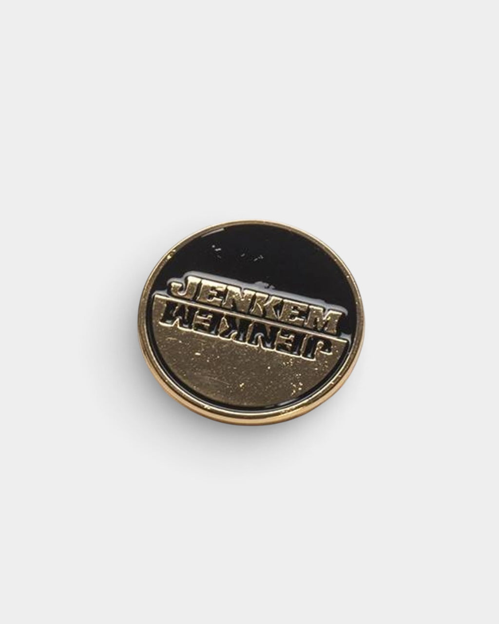 Lockwood Avenue Jenkem round enamel pin featuring a mirrored gold-tone logo on a black background.