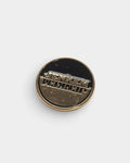 Lockwood Avenue Jenkem round enamel pin featuring a mirrored gold-tone logo on a black background.