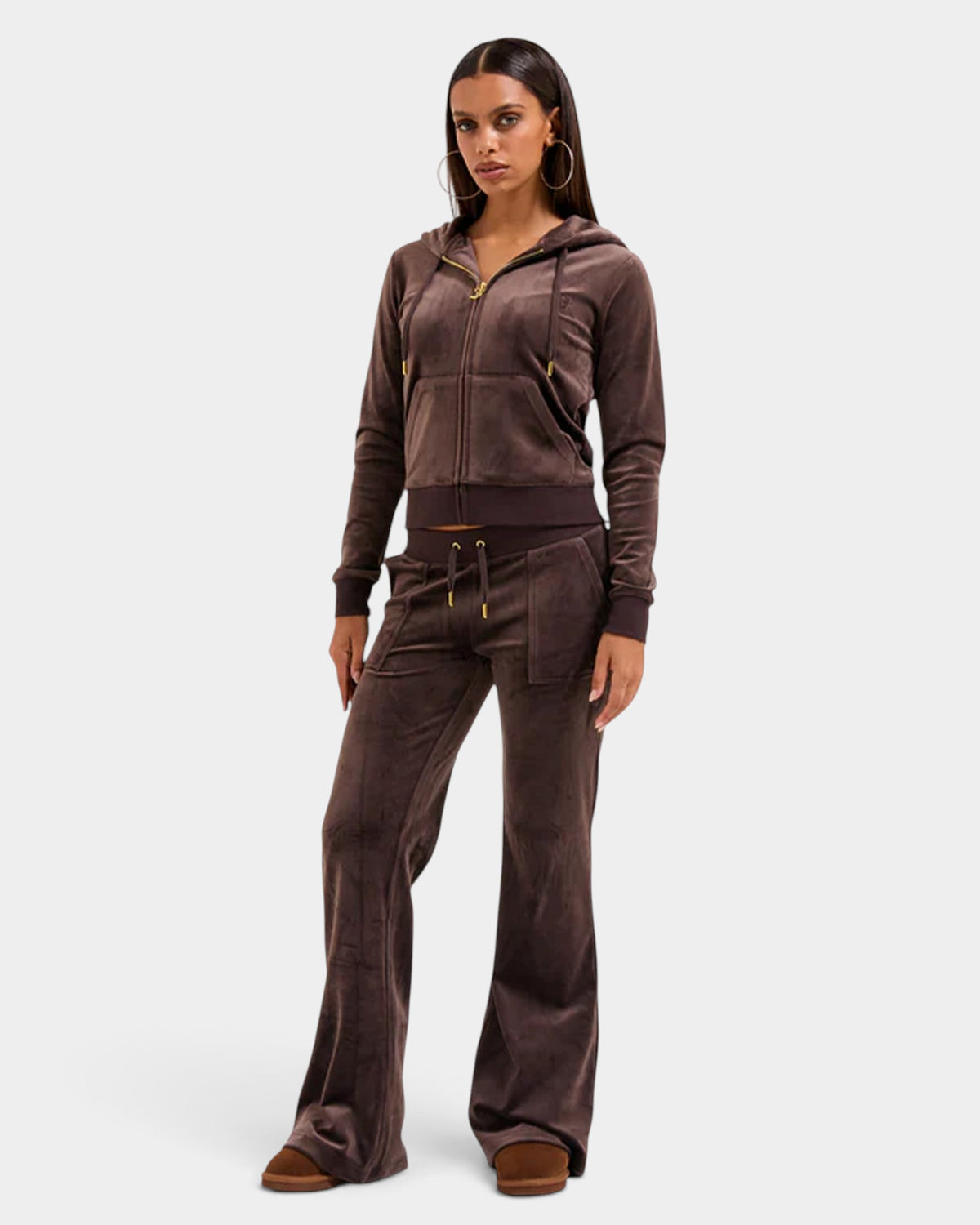 Lockwood Avenue model wearing a brown Juicy Couture velour zip hoodie and matching flared pants with gold hardware.