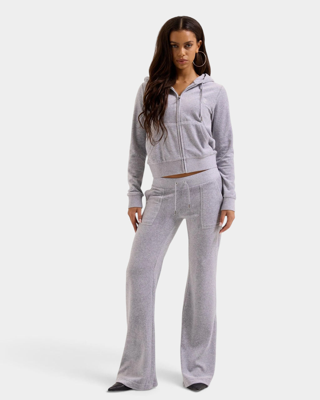 Lockwood Avenue model wearing a silver marl cotton velour Juicy Couture zip hoodie with gothic J pull and JC logo.