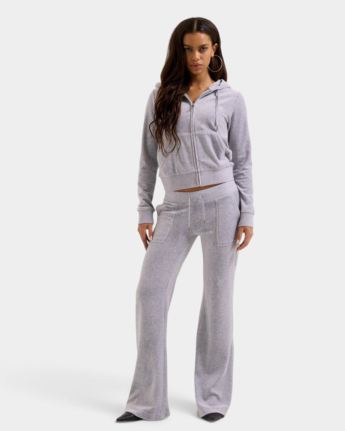 Lockwood Avenue model wearing a silver marl cotton velour Juicy Couture zip hoodie with gothic J pull and JC logo.