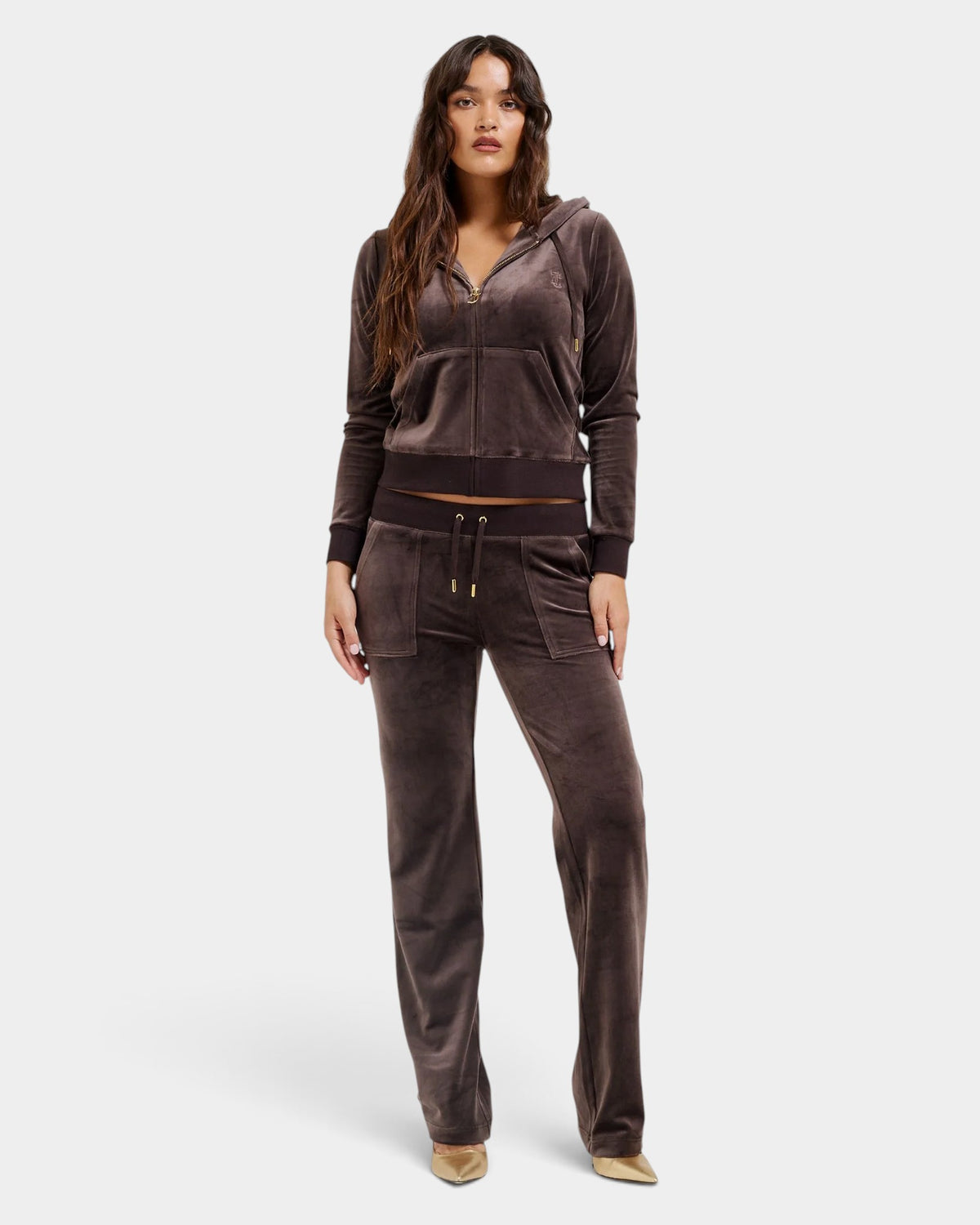 Lockwood Avenue model wearing a brown Juicy Couture velour track suit with a zip-up hoodie and flared pants.