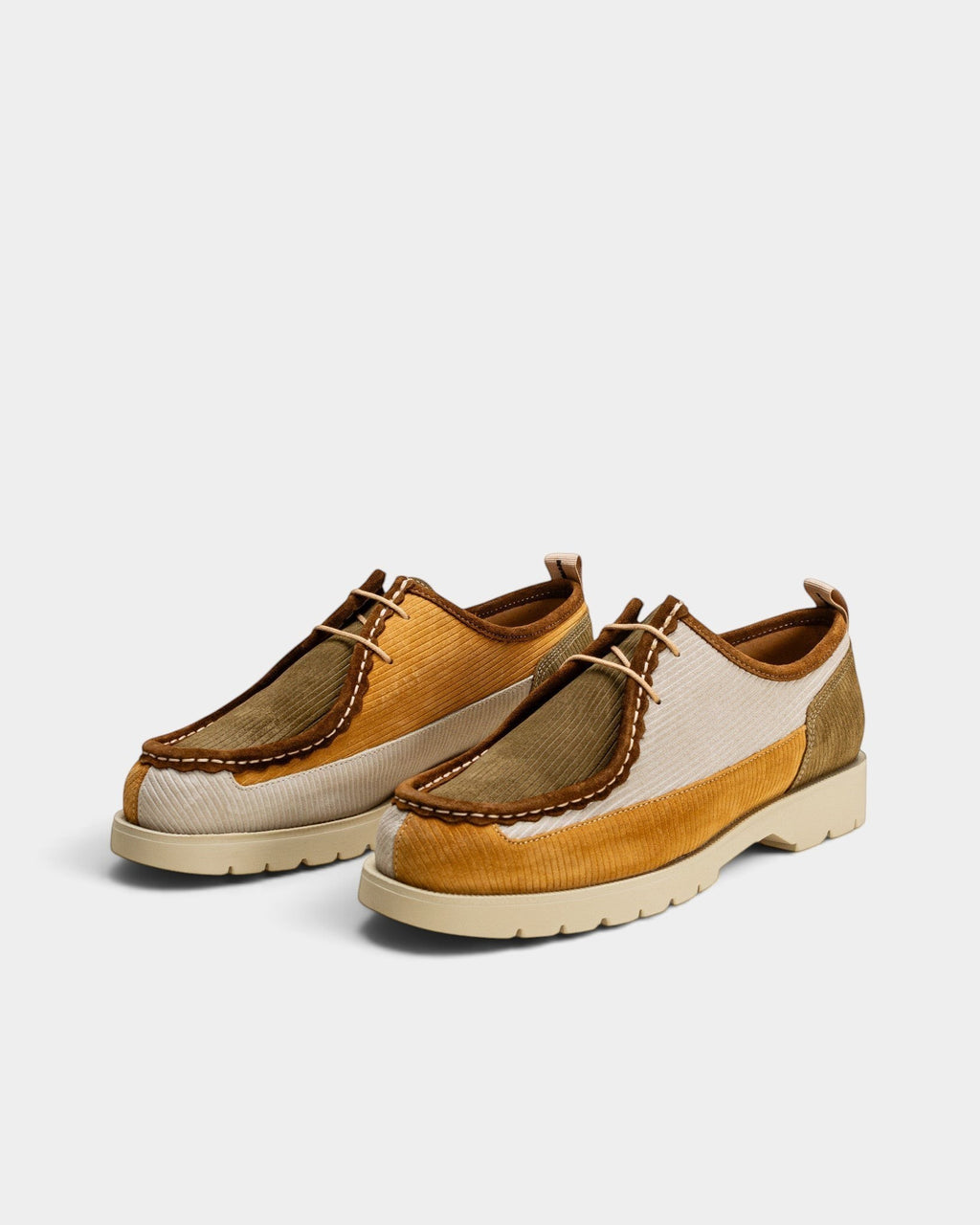 Lockwood Avenue Kleman Bastille low lace-up derby shoes in mustard, ecru, and khaki ribbed suede with a lug sole.