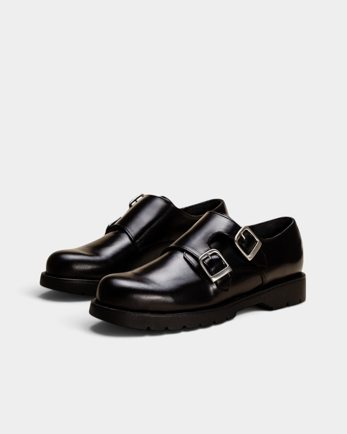Lockwood Avenue Kleman Postier B2 black leather monk-strap shoes with twin silver buckles and rubber soles.
