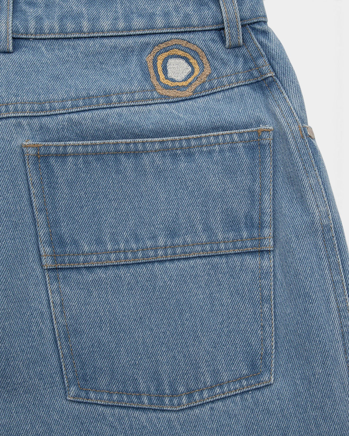 Lockwood Avenue Magic Castles Trip Jean featuring light blue denim, a large back pocket, and custom silk embroidery.