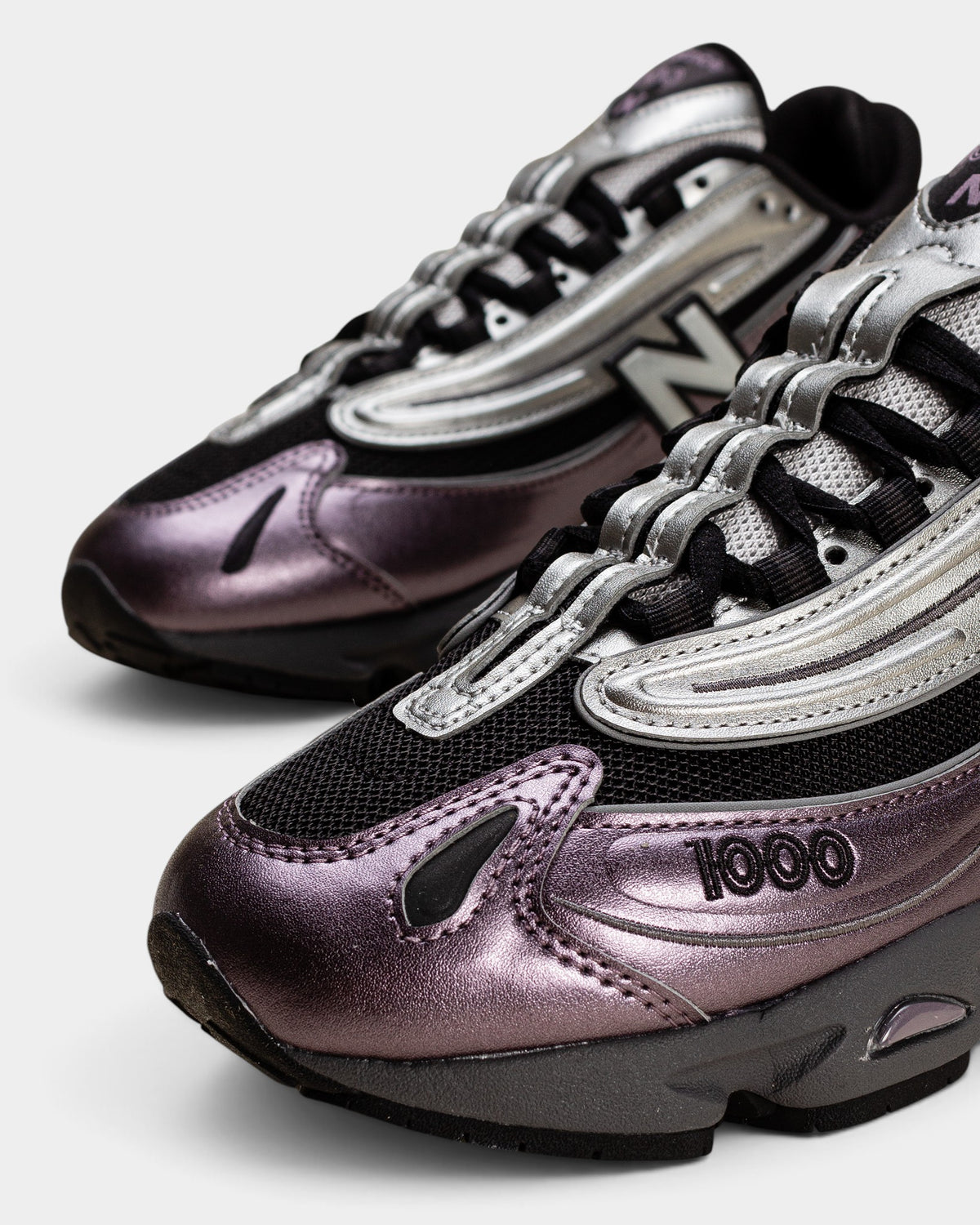 Lockwood Avenue New Balance 1000 sneakers in dark ice wine and metallic silver with mesh and suede detailing.