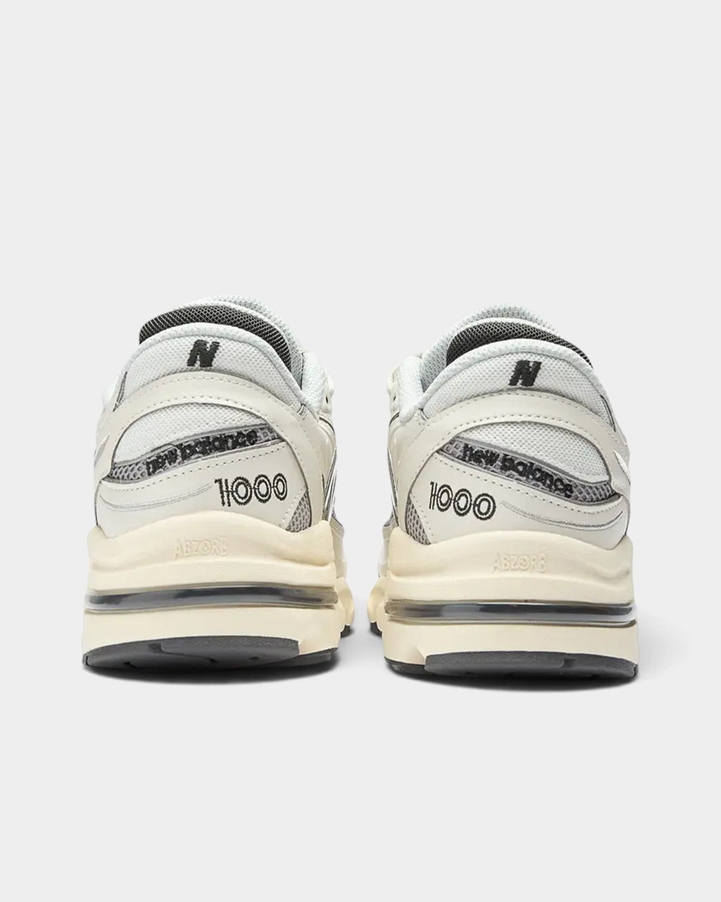 Lockwood Avenue New Balance 1000 sneakers in sea salt white leather and mesh with aged-look midsoles, rear view.
