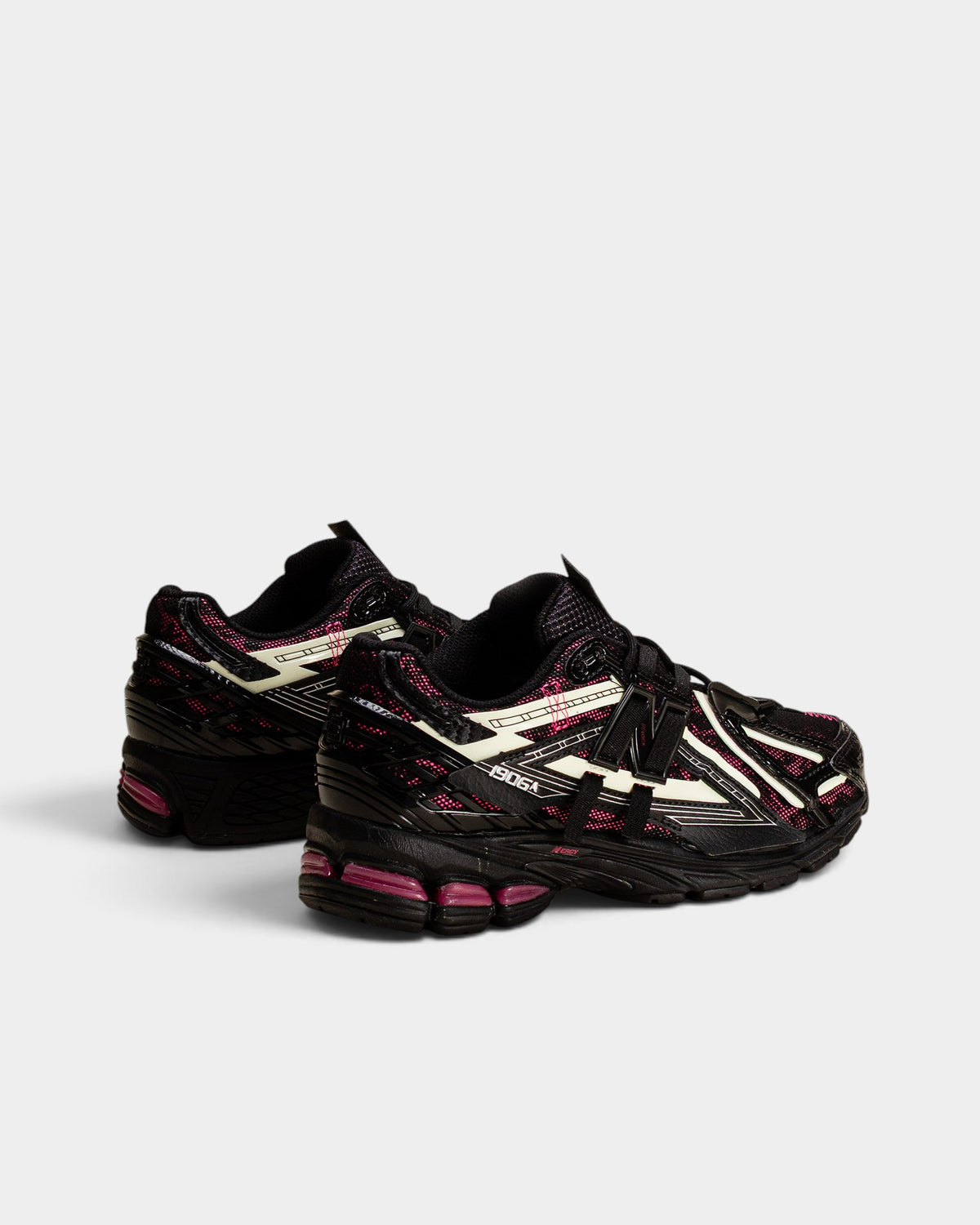 Lockwood Avenue New Balance 1906A sneakers in black with pink accents and glow-in-the-dark mesh running shoe details.