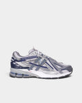 Lockwood Avenue New Balance 1906A sneakers in graphite gray mesh with blue synthetic overlays and N-ergy cushioning.