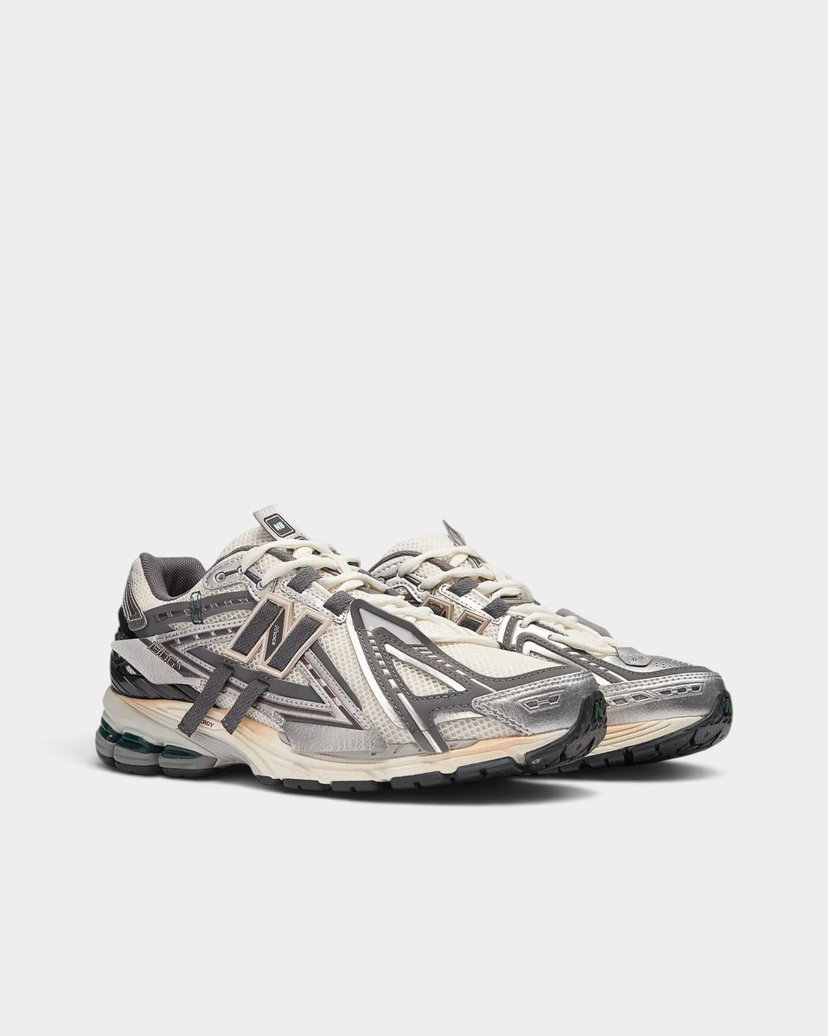 Lockwood Avenue New Balance 1906A sneakers in white mesh with silver, gold, and gray deconstructed metallic overlays.