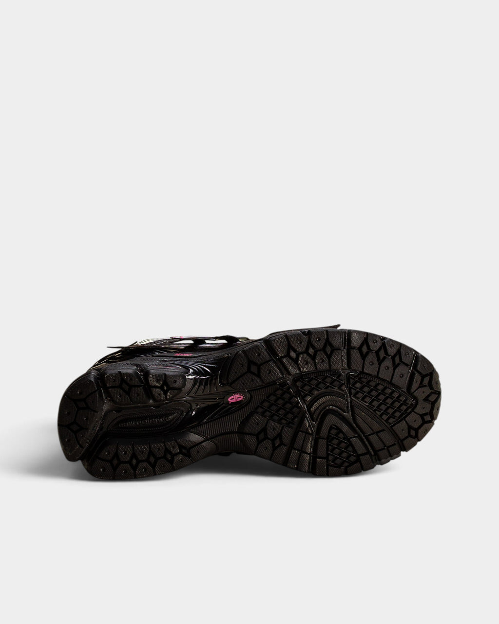 Lockwood Avenue New Balance 1906A sneaker showing the black rubber outsole with pink branding and textured tread.