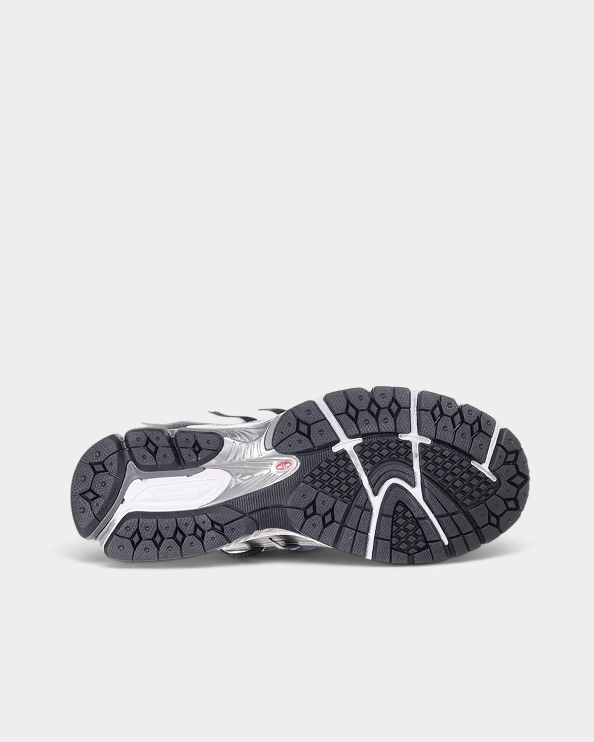 Lockwood Avenue New Balance 1906A running shoe showing the graphite gray and black rubber outsole tread pattern