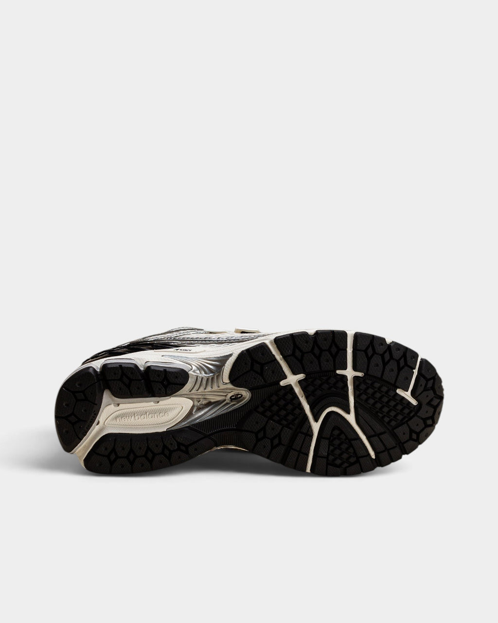 Lockwood Avenue New Balance 1906R sneaker showing the black and white N-ergy rubber outsole and cushioning details
