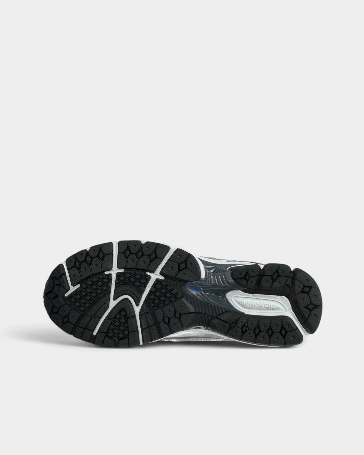 Lockwood Avenue New Balance 1906R performance runner shoe showing the black N-ergy rubber outsole and Stability Web.