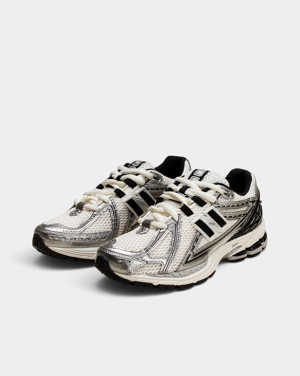 Lockwood Avenue New Balance 1906R sneakers featuring a white mesh upper, metallic silver overlays, and black accents.