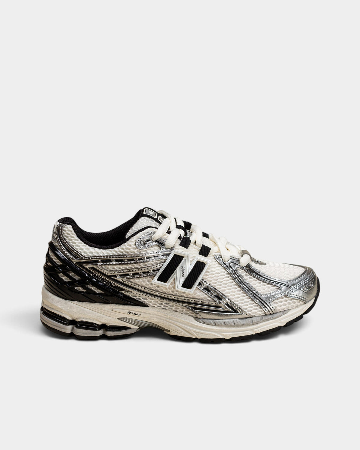 Lockwood Avenue New Balance 1906R running shoes in white mesh with metallic silver overlays and black accents.