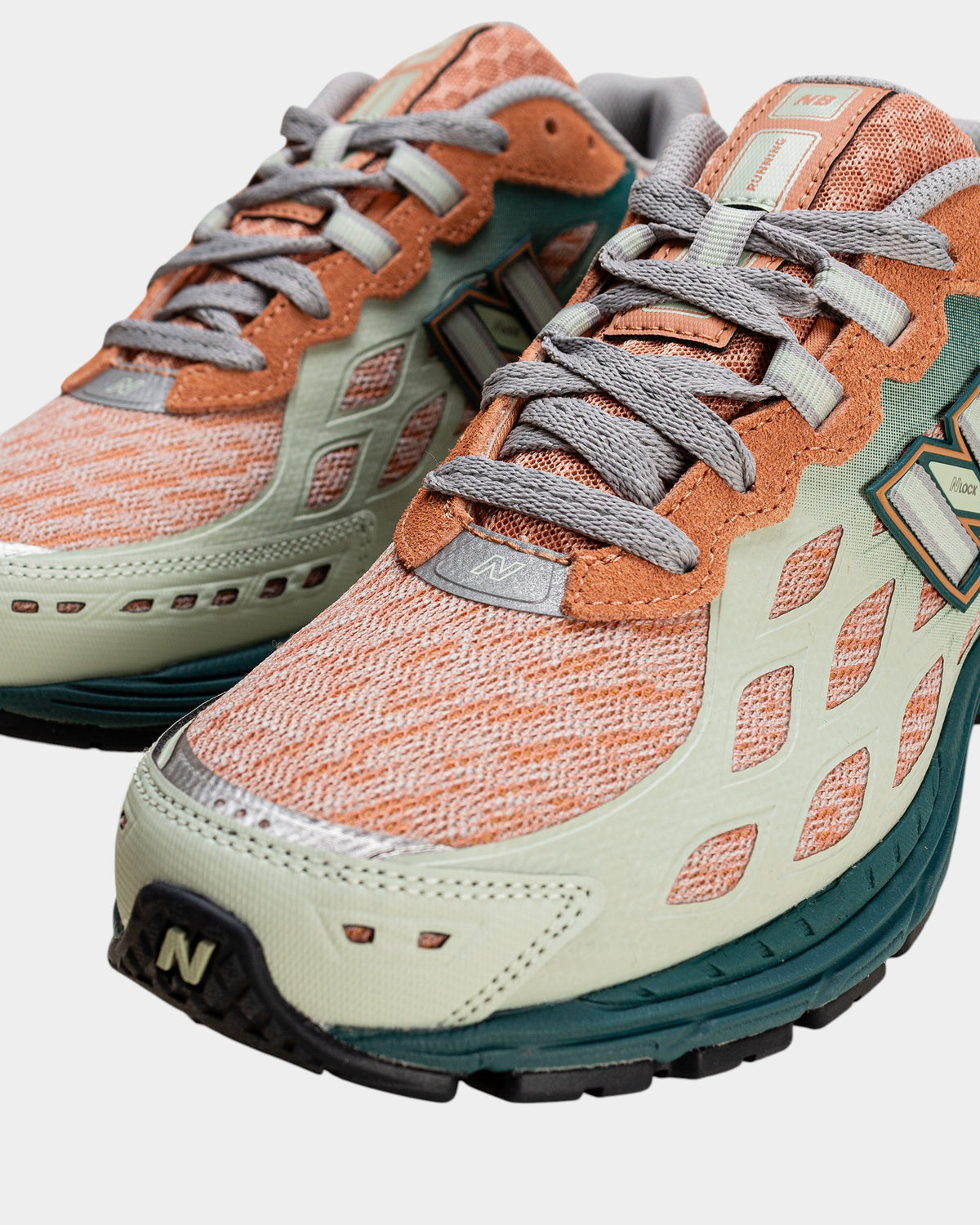Lockwood Avenue New Balance 1906W sneakers in spruce, sparrow, and mint with webbed mesh overlays and technical design.