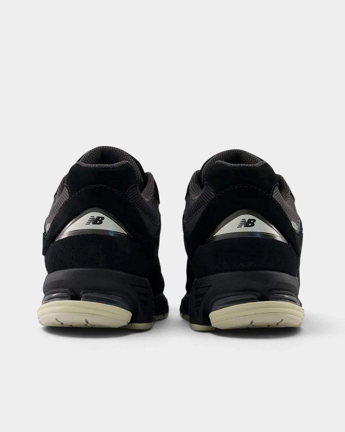 Lockwood Avenue New Balance 2002R sneakers in black and timberwolf gray suede and mesh, rear view showing heel detail.