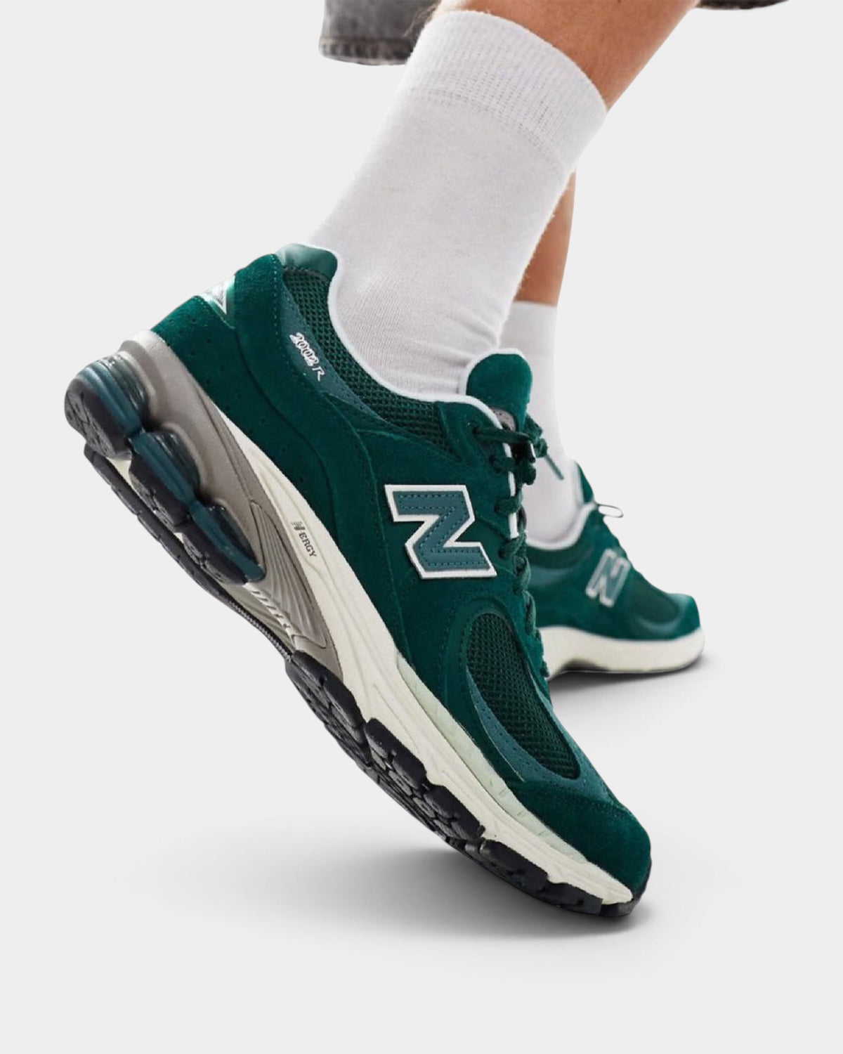 Lockwood Avenue New Balance 2002R sneakers in marsh green suede and mesh with sea salt accents on a model