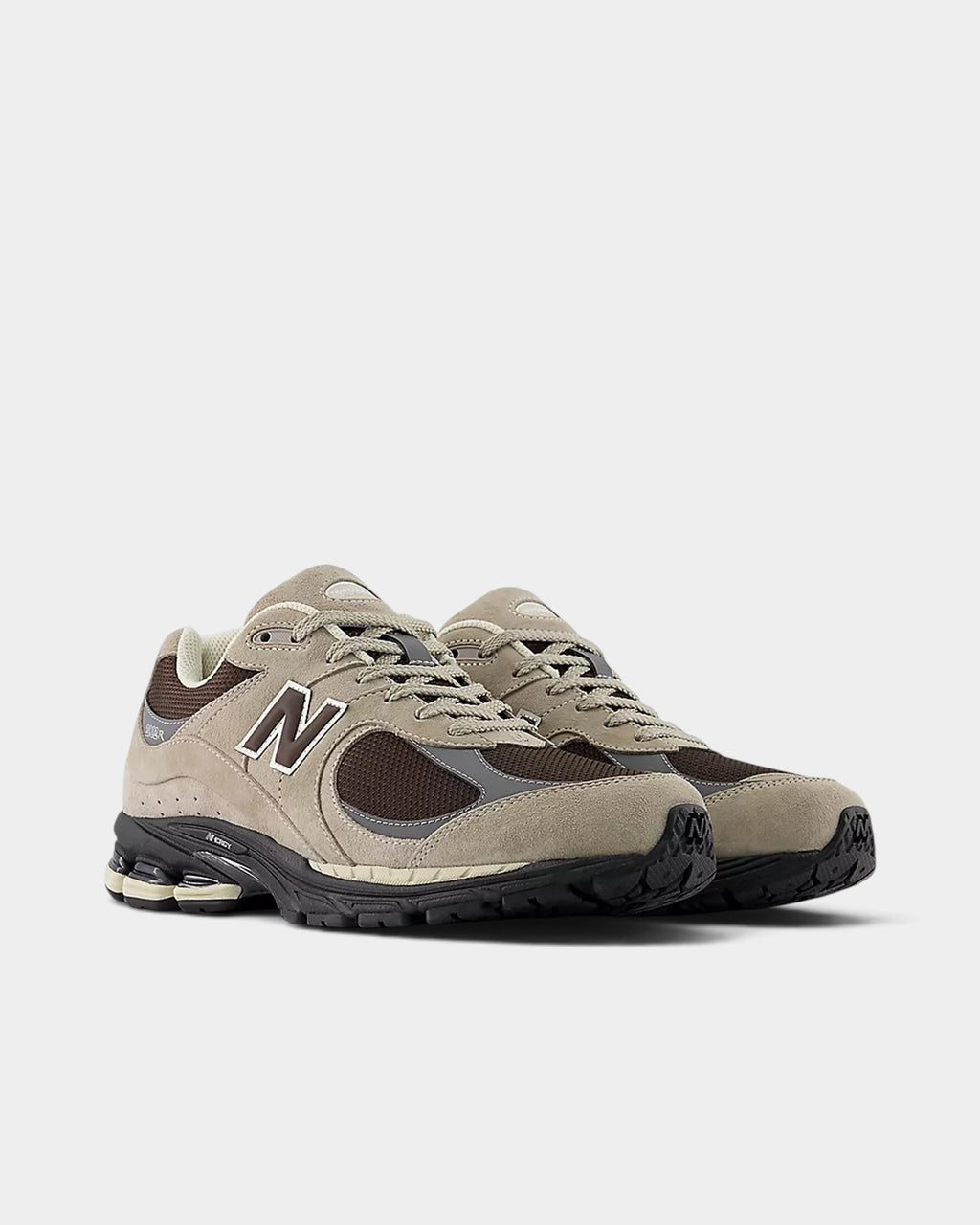 Lockwood Avenue New Balance 2002R sneakers in arid stone suede and black coffee mesh with cushioned midsole.
