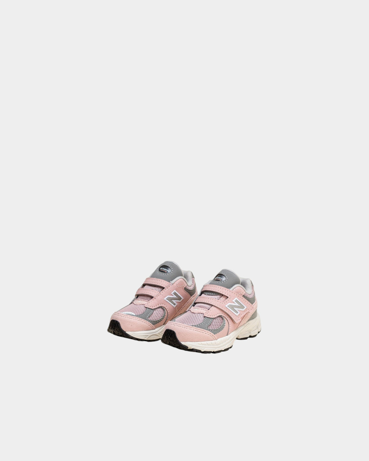 Lockwood Avenue New Balance 2002R toddler shoes in orb pink and shadow grey with mesh, suede, and hook-and-loop strap.