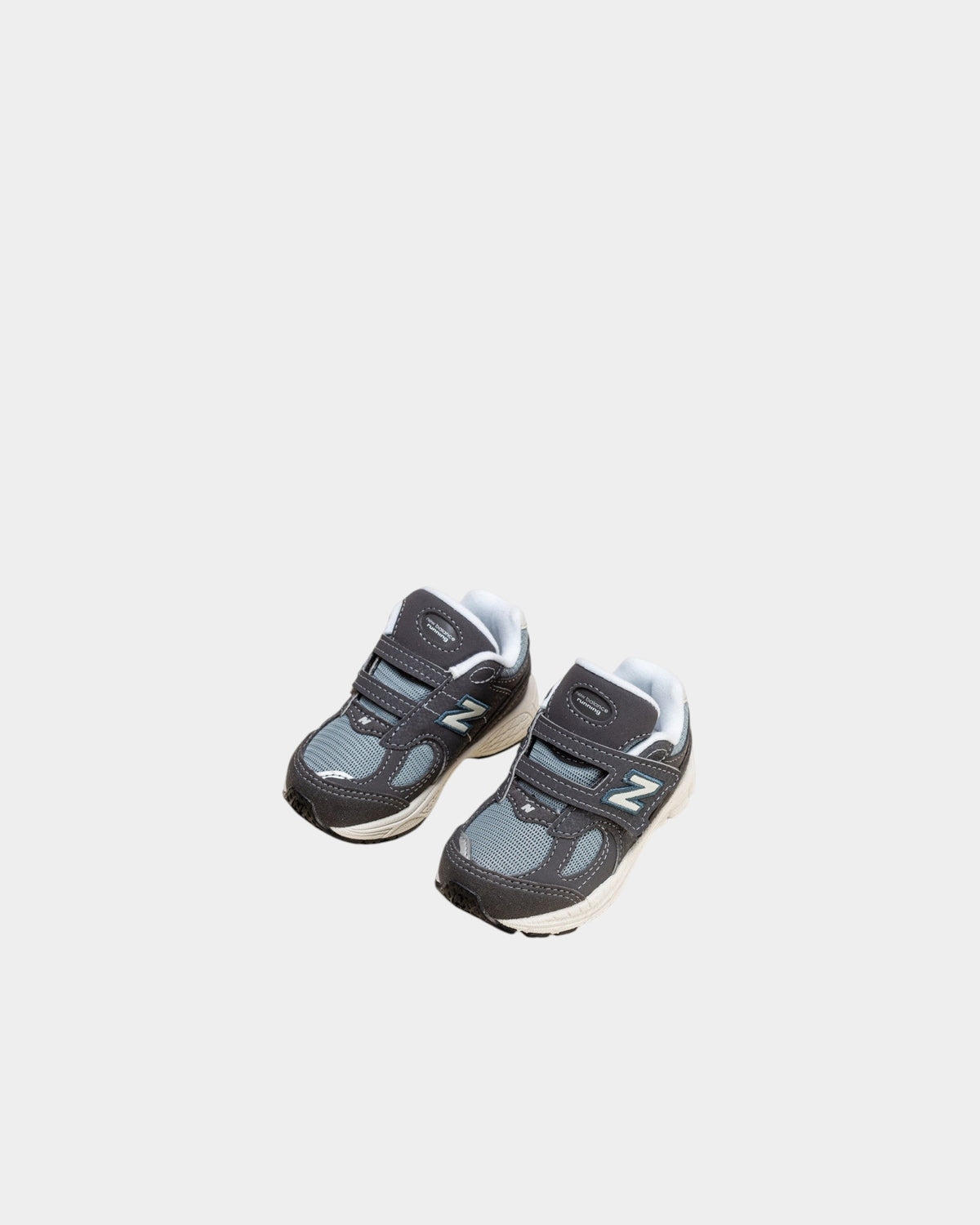 Lockwood Avenue New Balance 2002R toddler shoes in magnet and lead gray with mesh, suede, and hook-and-loop straps.