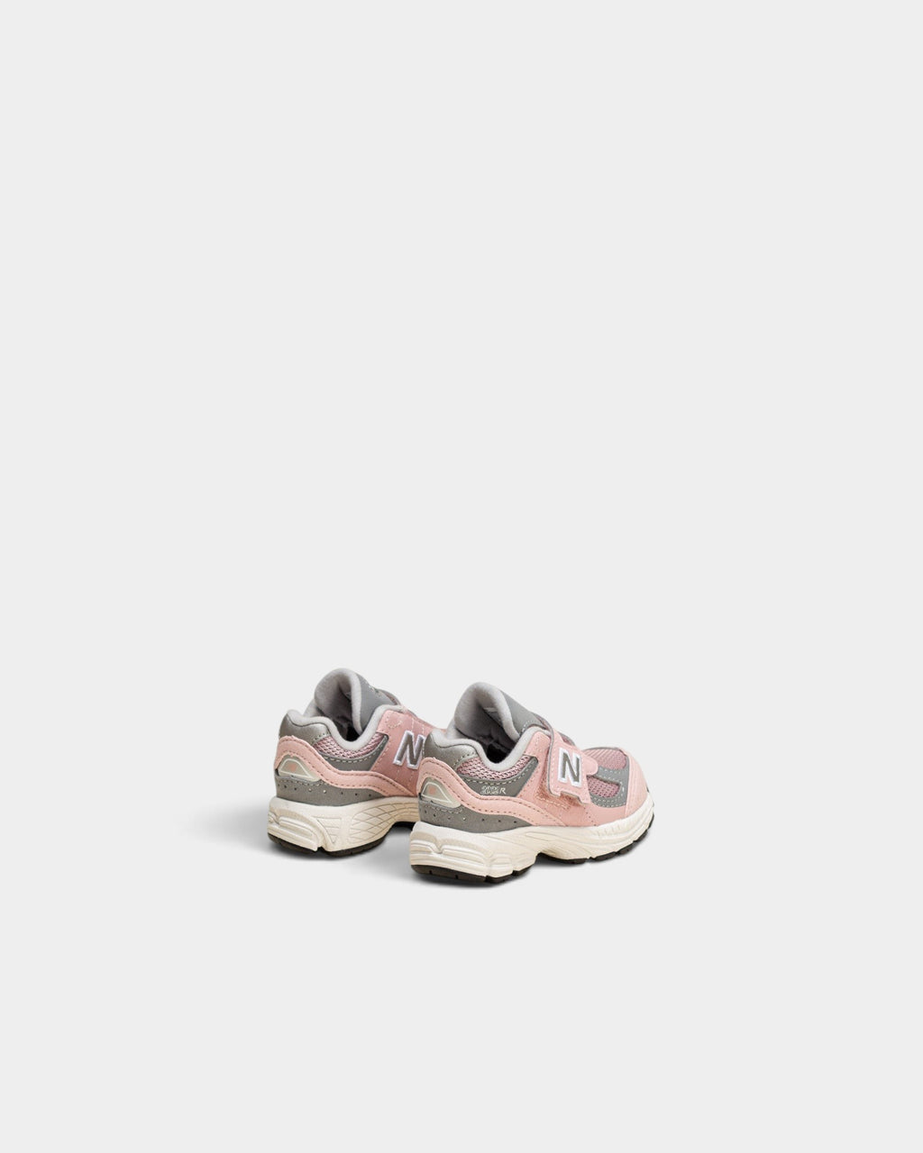 Lockwood Avenue New Balance 2002R toddler shoes in orb pink and shadow grey with mesh and suede details.