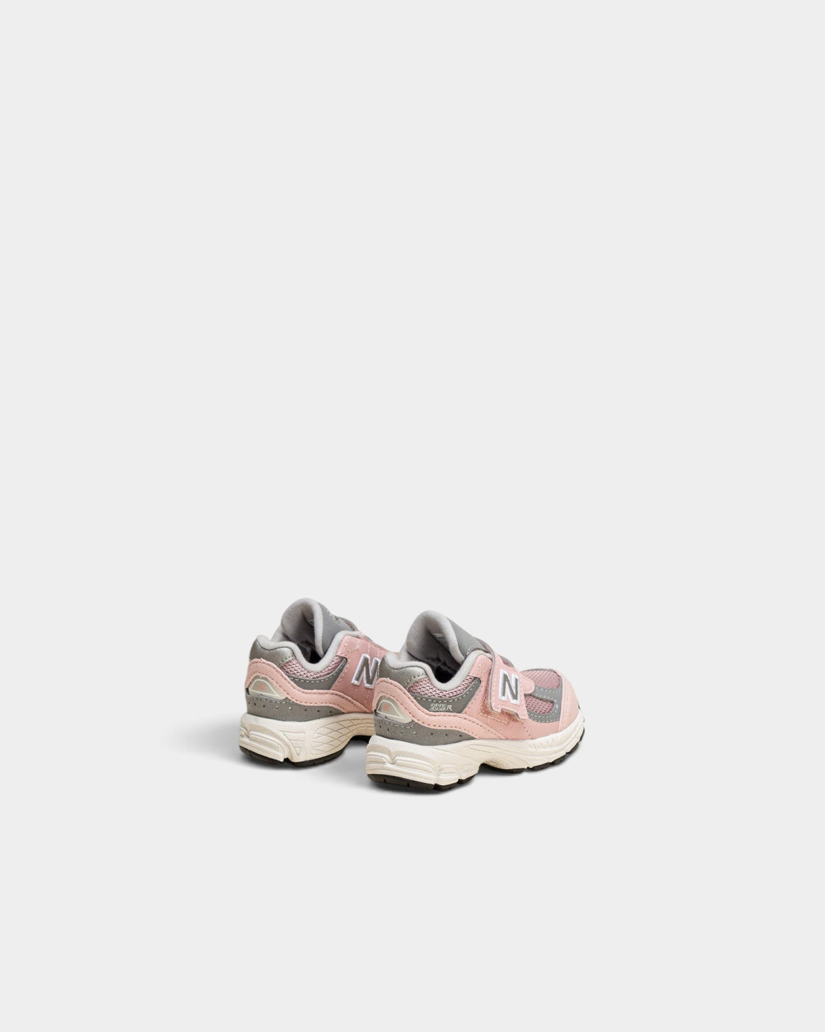 Lockwood Avenue New Balance 2002R toddler shoes in orb pink and shadow grey with mesh and suede details.