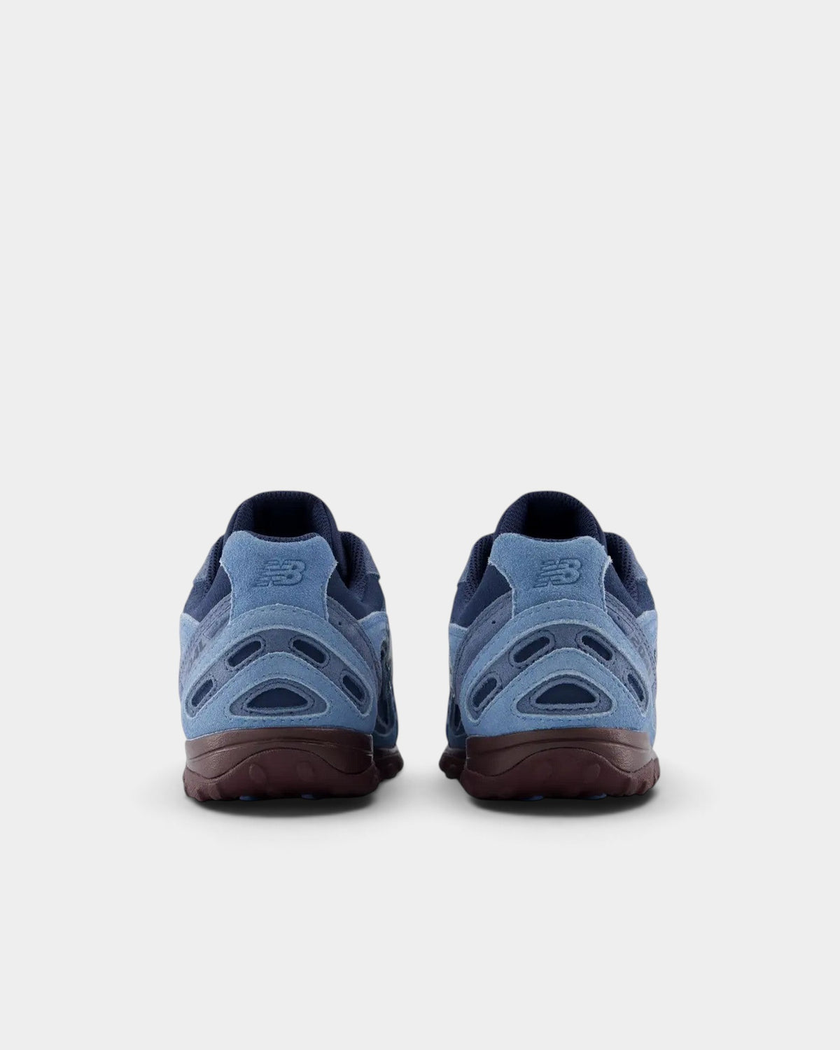 Lockwood Avenue New Balance 204 sneakers in blue suede and mesh with a plum-brown outsole, rear view.