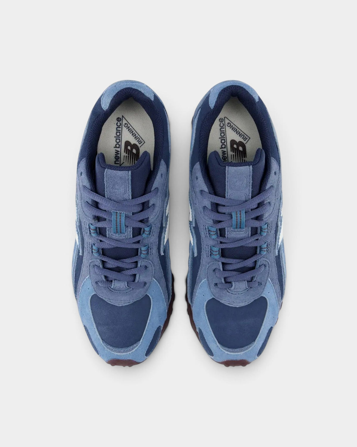 Lockwood Avenue New Balance 204 sneakers in blue suede and mesh with a plum-brown outsole, top-down view.