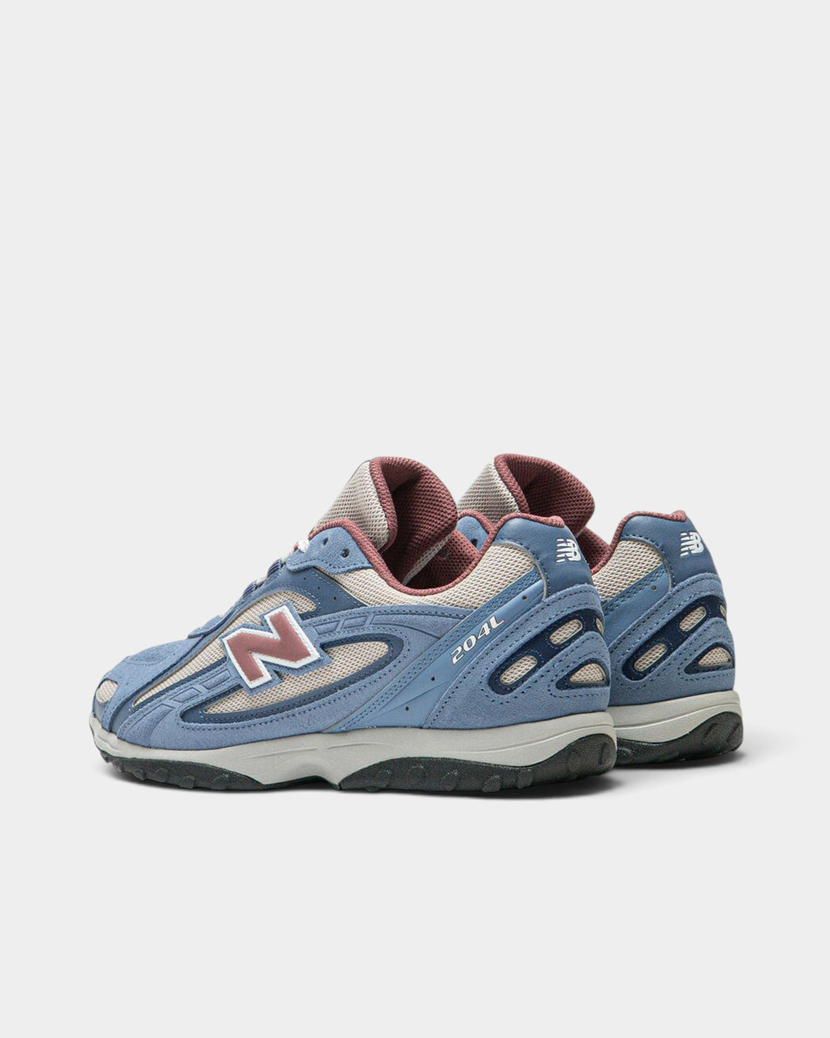 Lockwood Avenue New Balance 204L lifestyle runner in blue suede and off-white mesh with clay red accents.