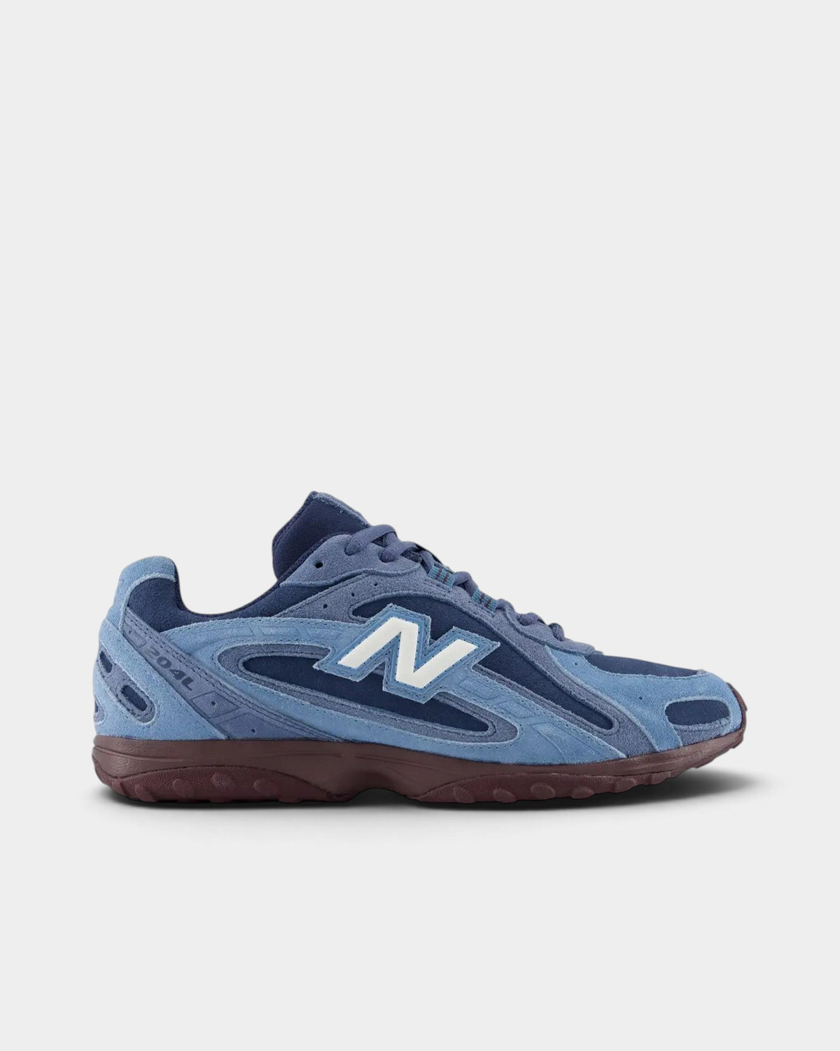 Lockwood Avenue New Balance 204L sneakers in blue suede and mesh with a plum-brown outsole and white N logo.