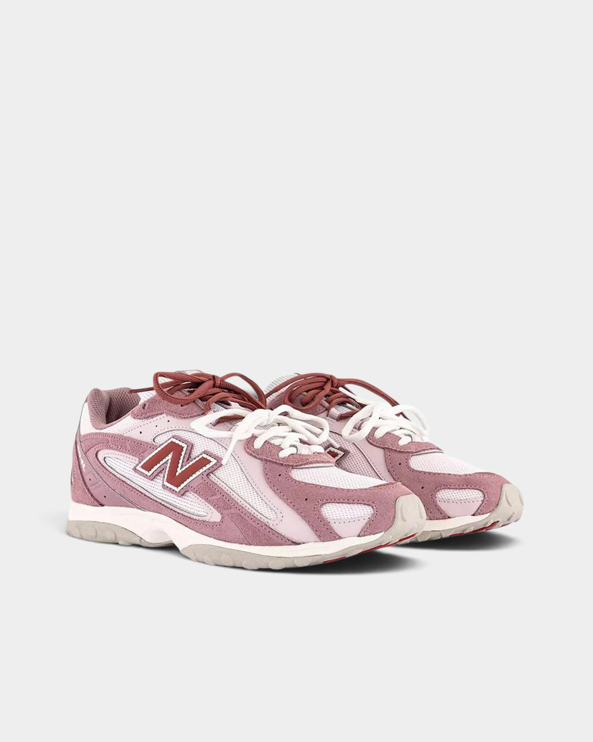 Lockwood Avenue New Balance 204L sneakers in rosewood suede and mesh with pink, white, and red accents.