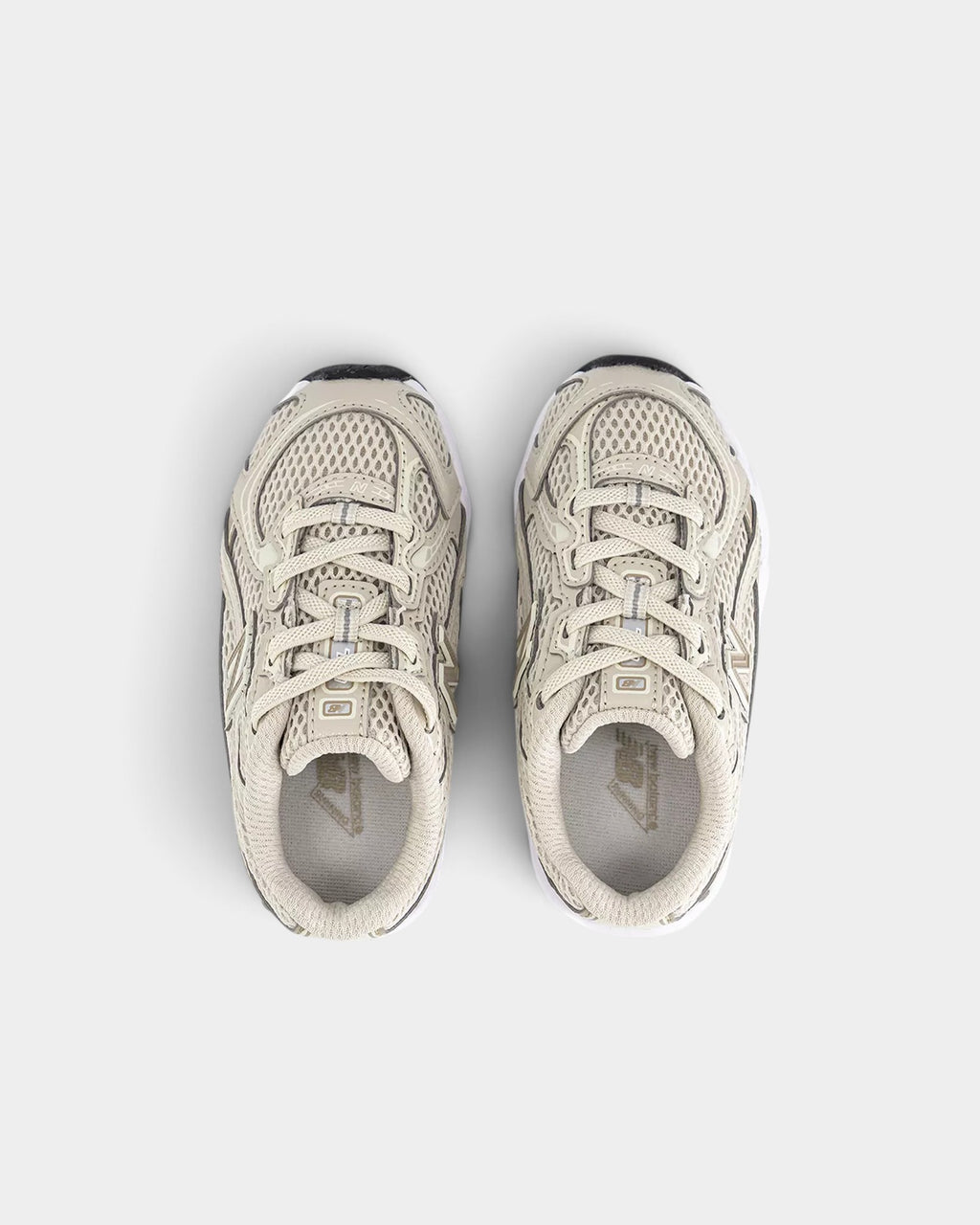 Lockwood Avenue New Balance 530 toddler shoes in timberwolf and stoneware mesh with ABZORB cushioning, top view.