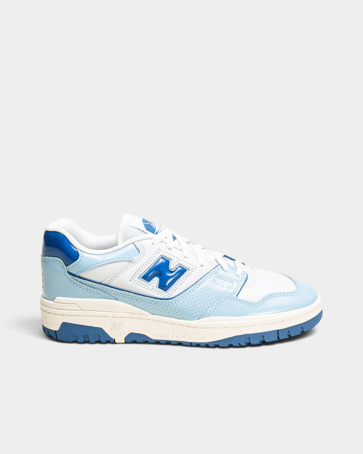 Lockwood Avenue New Balance 550 low-top sneakers in white leather with glossy blue patent leather overlays.