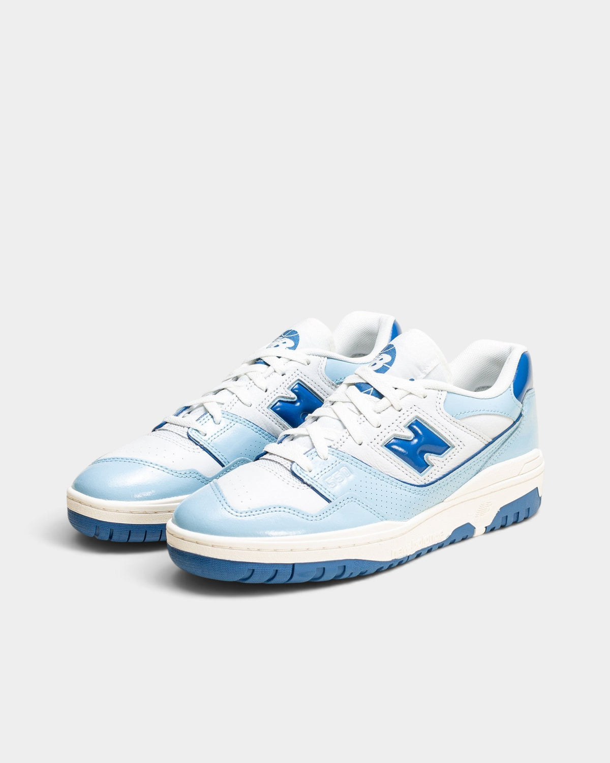 Lockwood Avenue New Balance 550 low-top sneakers in white leather with glossy blue patent leather overlays.