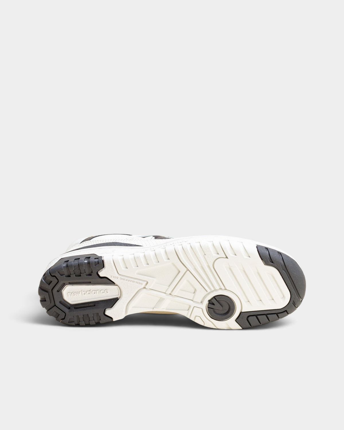 Lockwood Avenue New Balance 550 women's sneaker showing the durable rubber cupsole tread pattern in off-white and gray.
