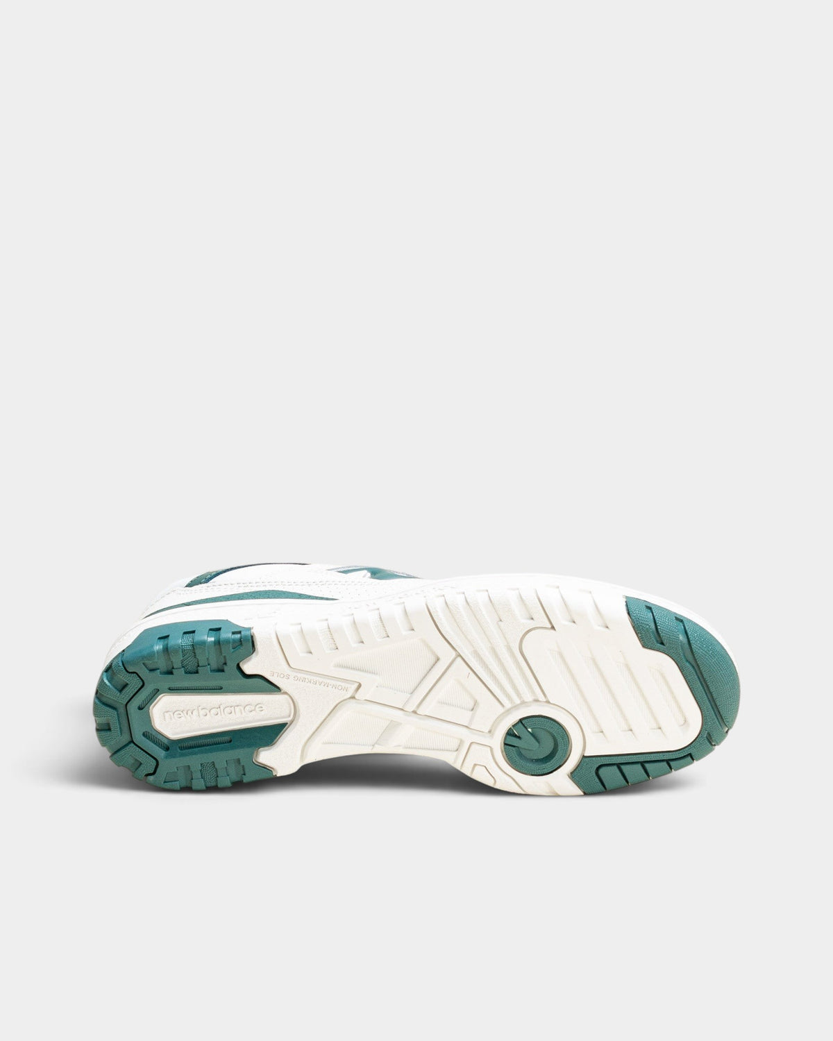 Lockwood Avenue New Balance 550 women's sneaker showing the white and spruce green rubber outsole tread pattern